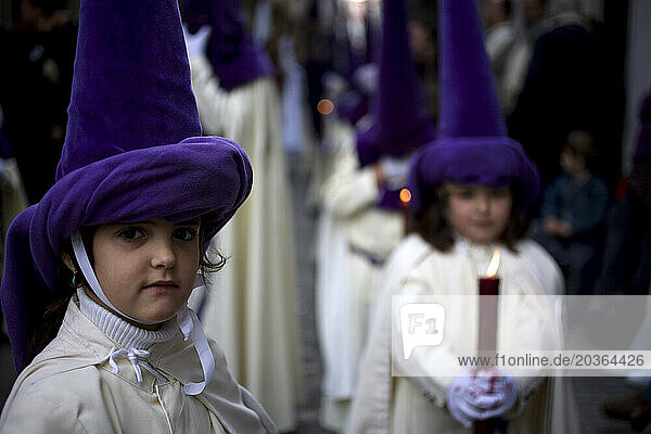 Children participate in an Holy Week procession in Cadiz in Spain's Andalucia region