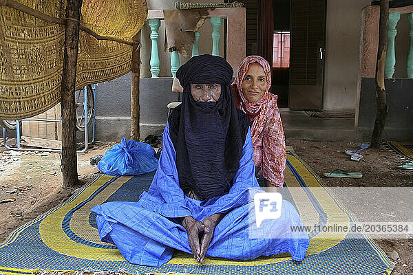 A Muslim Toureg husband and wife sitting on a mat wearing turban and shawl  Mali  West Africa