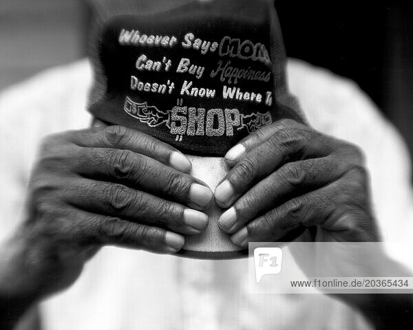 Detail shot of an older African Americans hands holding a hat.