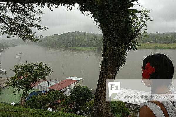 A woman looks down at the river from a hill in Nicaragua.