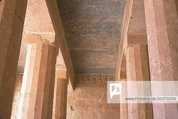 Low angle view of similar pillars under the ceiling.