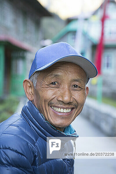 Portrait of smiling Sherpa guide in village of Phakding on way to Everest Base Camp  Khumbu  Nepal