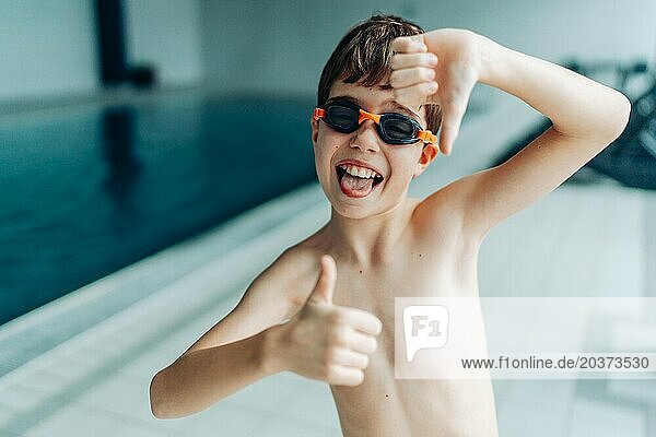 Boy learning to swim in a pool in daylight