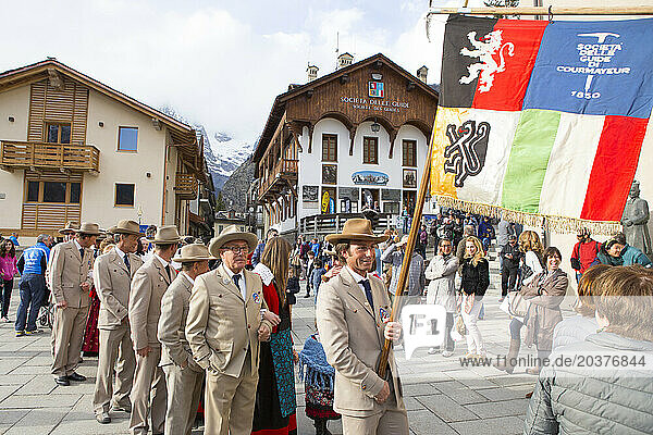 A group of Italian mountain guides are dressed in traditional clothing of the Guide Alpine Courmayeur for a parade through the village of Courmayeur.