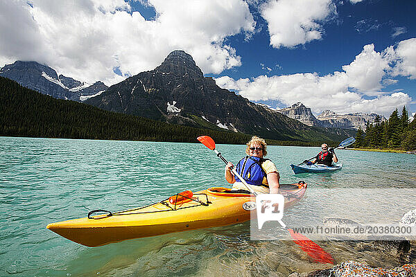 Senior couple kayaking on Waterfowl Lake  Canadian Rockies  Alberta  Canada