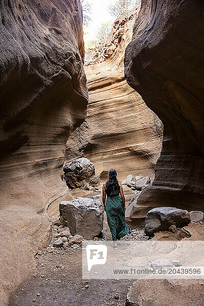 Woman walking near rocks in Barranco de Las Vacas  Gran Canaria  Spain
