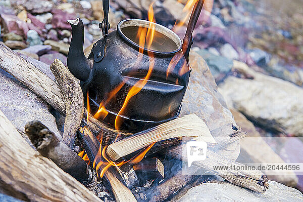 Kettle kept on campfire in forest