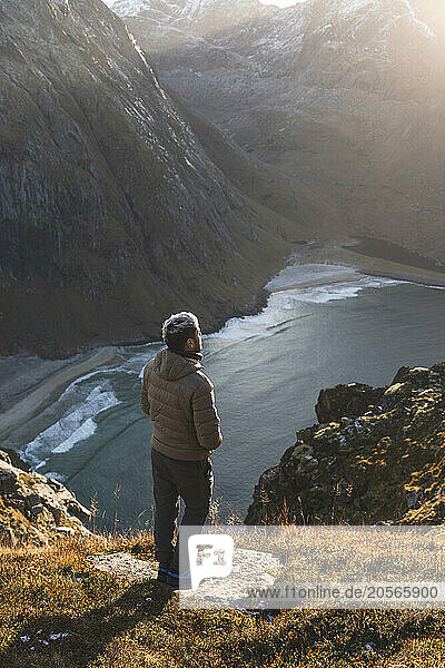Young man standing with on rock at Lofoten and Nordic islands  Norway
