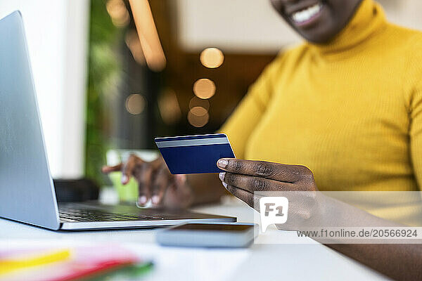 Hand of businesswoman holding credit card at office