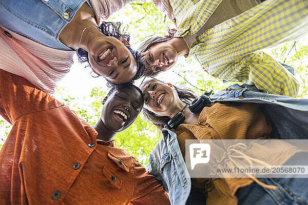 Happy women huddling together at park