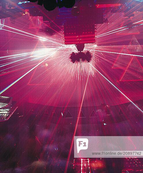 England. London. Laser light show and people dancing at The Qube Project nightclub.