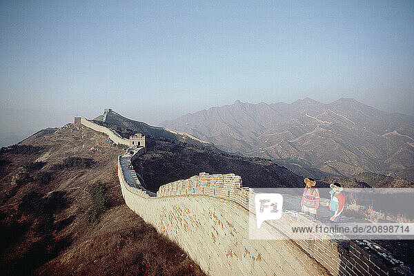 China. Jinshanling. Two women tourists standing on Great Wall of China.