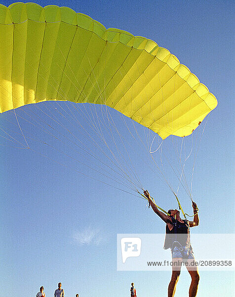 Australia. Victoria. Paraglidist preparing for flight.