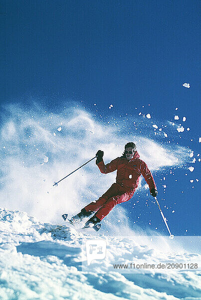 Australia. Falls Creek. Young man downhill snow skiing.