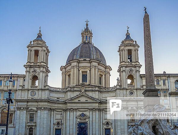 View of Sant'Agnese in Agone and Fountain of Four Rivers at Piazza Navona at sunset in Rome  Italy
