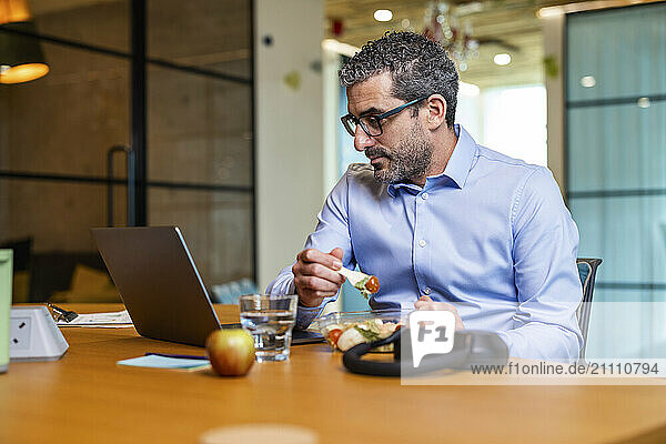 Businessman enjoying lunch break at co working space