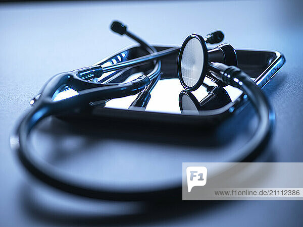 Stethoscope on a metal tray with reflection  used for heart monitoring and medical tests in healthcare.