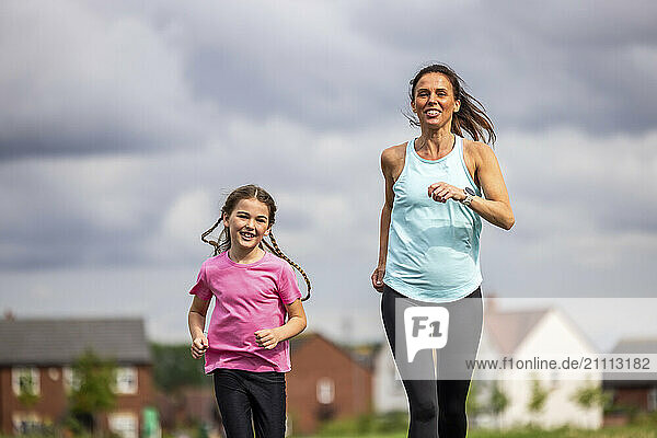 Happy mother and daughter running together