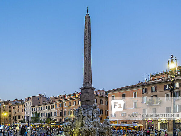 View of Fountain of Four Rivers at Piazza Navona at dusk in Rome  Italy