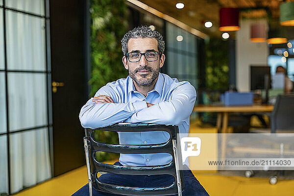 Businessman sitting on chair and relaxing at co working space