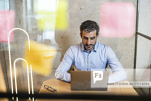 Businessman working on laptop at co working space