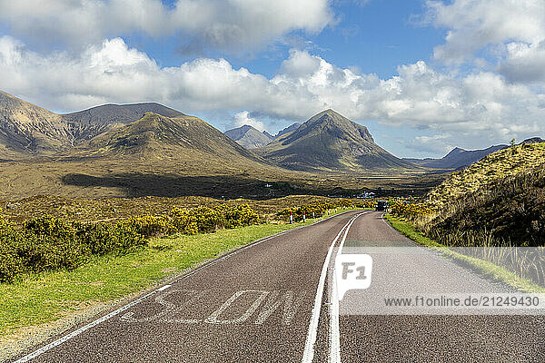 Scenic road and mountain landscape on the Isle of Skye  Scotland with an empty highway and no people.