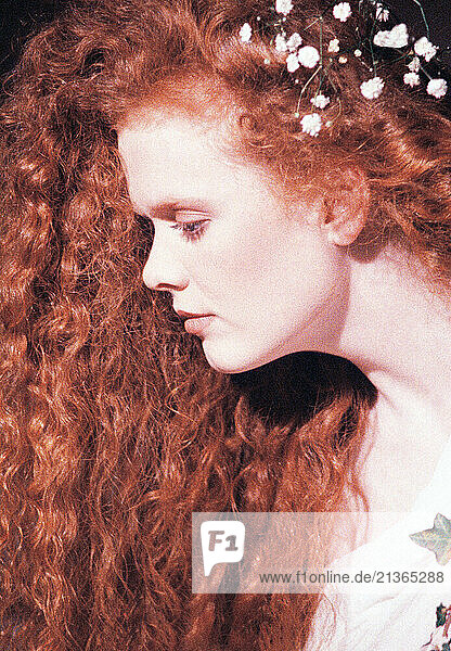 Studio portrait of young woman with red hair.
