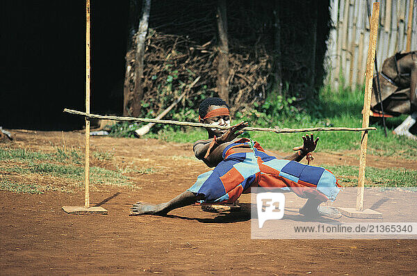 Kenya. Boy Limbo dancing.