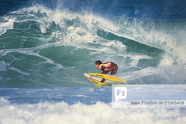 Australia. Sydney. Young man surfing a breaking wave.