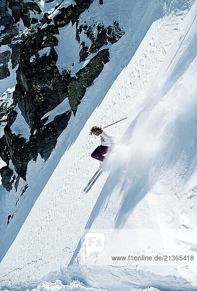 New Zealand. Young man downhill skiing.