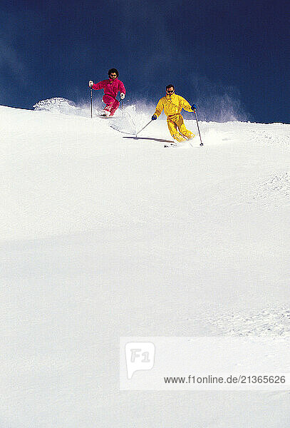 Australia. Snow skiing. Young men downhill skiing.