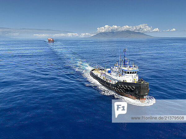 Aerial view of the tug boat Manuokekai pulling a barge with shipping containers through the Alalakeiki Channel  South Maui  Hawaii  USA; Maui  Hawaii  United States of America
