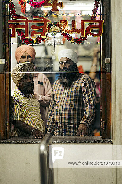 Men visiting the Golden Temple  a Sikh Gurdwara in Amritsar  Punjab  India; Amritsar  Punjab  India