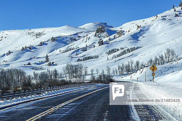 Winding interstate at snow covered foothills