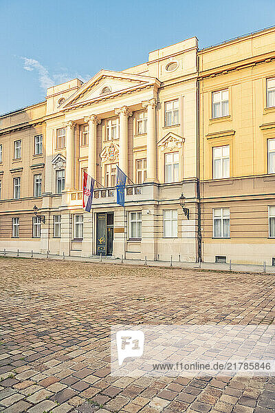 Evening sun illuminates the croatian parliament building adorned on St. Mark s Square with the Croatian and European Union flags  Zagreb  Croatia