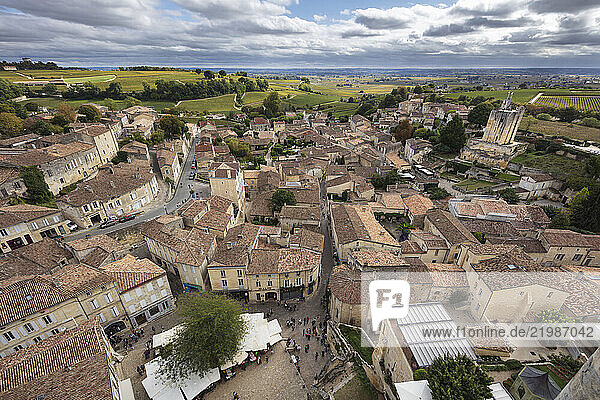 View over the medieval old town with vineyards in distance viewed from the top of the monolithic church bell tower  Saint Emilion  Gironde Department  Nouvelle Aquitaine  France  Europe