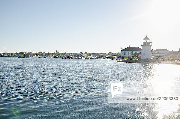 Brant Point Lighthouse and harbor with water reflecting sunlight