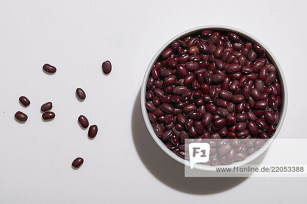 Overhead view of bowl of kidney bean on white background