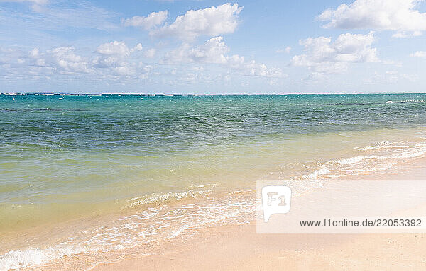 Calm sea waves on sandy beach