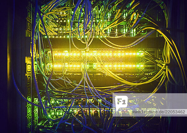 Close-up of hard drives and cables in data center