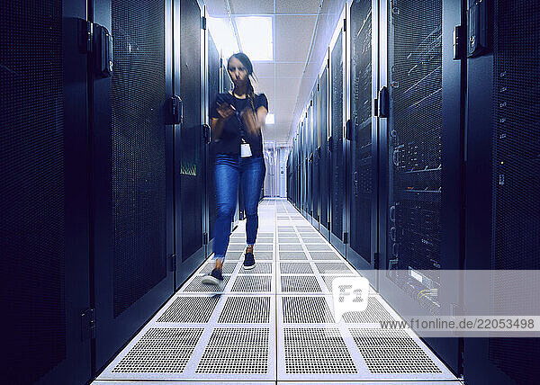 Female technician walking in server room