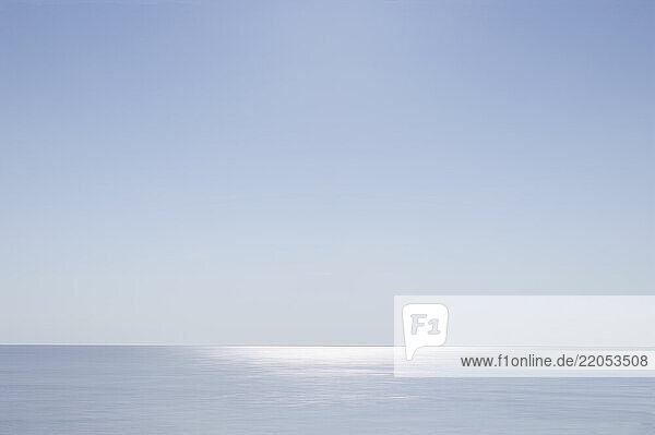 Pale blue sky and horizon over calm Atlantic Ocean