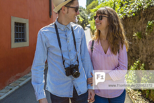 Affectionate couple strolling through narrow alleys in Florence  Tuscany  Italy