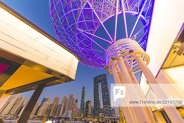 Middle East  United Arab Emirates  Dubai. In the background  Dubai Marina with the distinctive silhouette of the Address Beach Resort at The Walk. Dubai Marina. Bluewaters Island. Giant tree-shaped structures