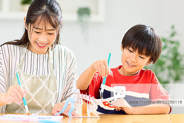 Japanese Mother And Son Painting With Colored Pencils