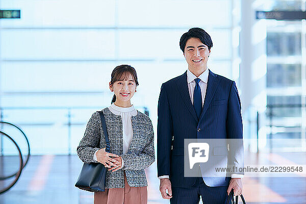 Japanese Business Couple Standing In An Airport