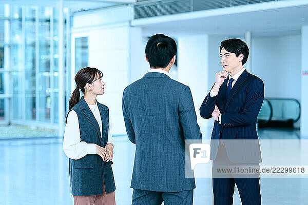 Japanese Business People Talking In An Office