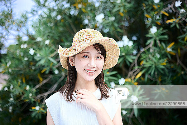 Japanese Woman Wearing A At And Smiling