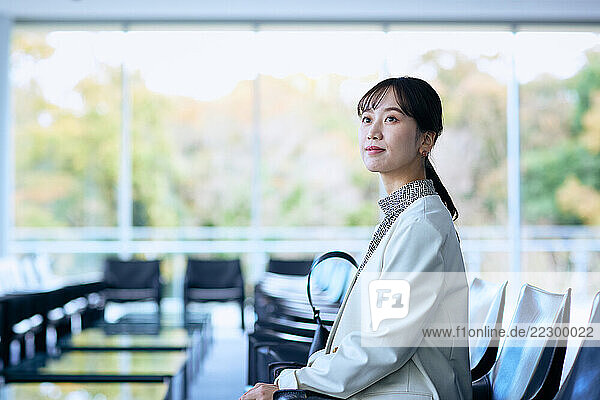 Japanese Businesswoman Sitting In An Office Chair