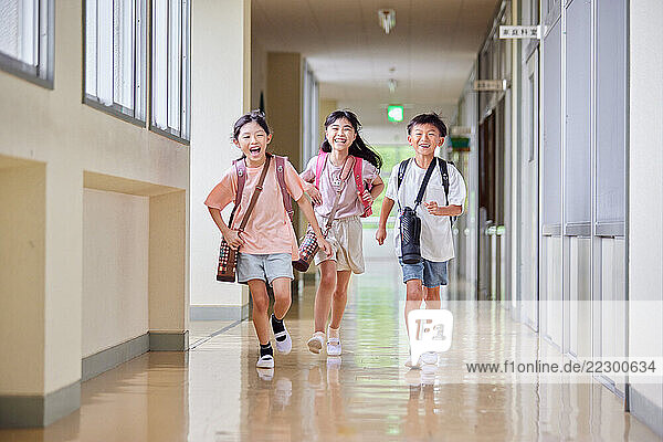 Japanese Kids Walking Down A School Hallway